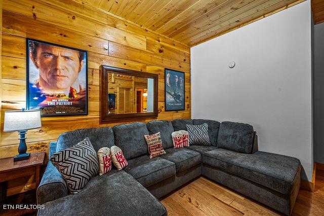 3322 Covered Bridge Way, Sevierville, TN 37862 - living room featuring wooden walls, wood ceiling, and wood finished floors