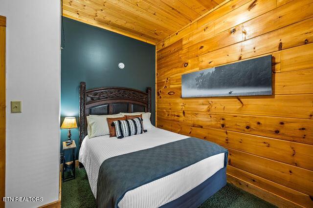 3322 Covered Bridge Way, Sevierville, TN 37862 - bedroom with carpet, wooden ceiling, and wooden walls