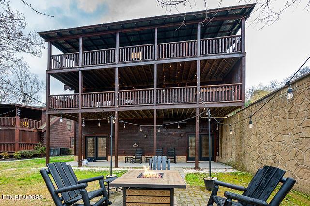 3322 Covered Bridge Way, Sevierville, TN 37862 - back of house with an outdoor fire pit, french doors, a patio area, and a balcony