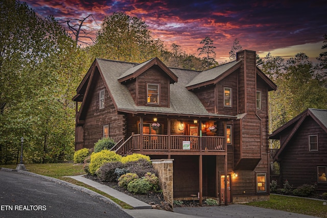 3322 Covered Bridge Way, Sevierville, TN 37862 - log home with a chimney, a shingled roof, and covered porch