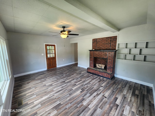 308 E Prospect St, Lafollette, TN 37766 - unfurnished living room featuring wood finished floors, a brick fireplace, a ceiling fan, and beam ceiling