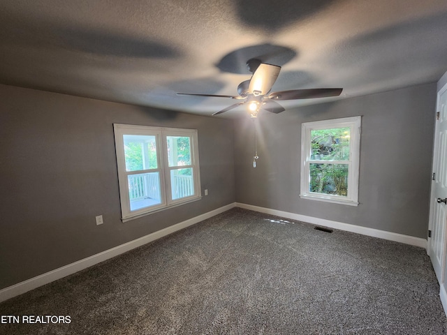 308 E Prospect St, Lafollette, TN 37766 - unfurnished room featuring ceiling fan, dark colored carpet, and a textured ceiling