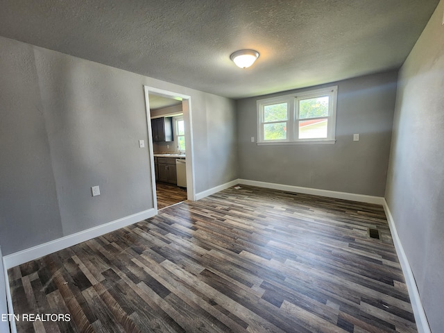 308 E Prospect St, Lafollette, TN 37766 - unfurnished room featuring dark wood-style floors and a textured ceiling