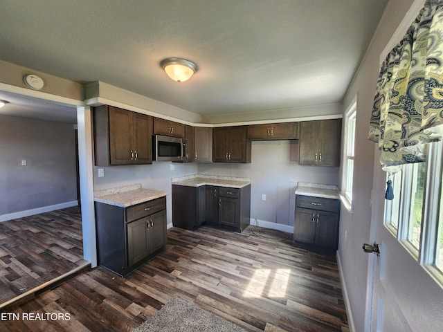 308 E Prospect St, Lafollette, TN 37766 - kitchen featuring stainless steel microwave, dark brown cabinetry, dark wood finished floors, and light countertops
