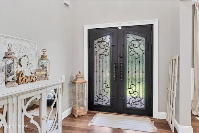 foyer featuring french doors and wood finished floors