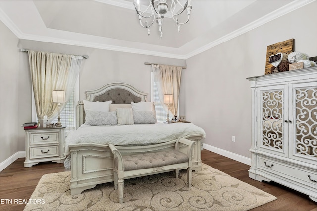 bedroom with a chandelier, multiple windows, dark wood finished floors, and ornamental molding