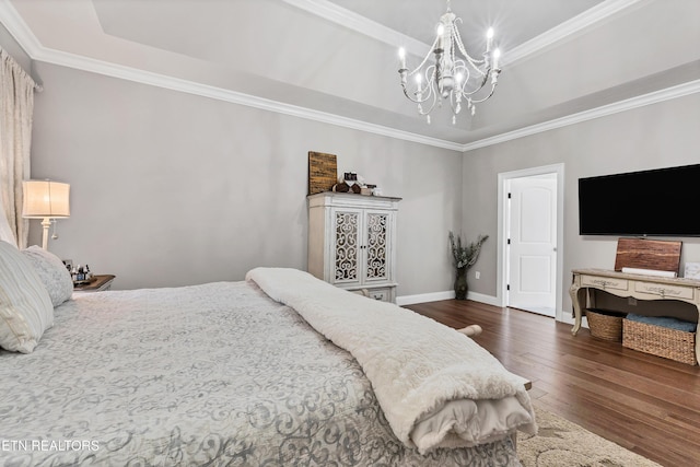 bedroom with a raised ceiling, dark wood-style flooring, a chandelier, and crown molding