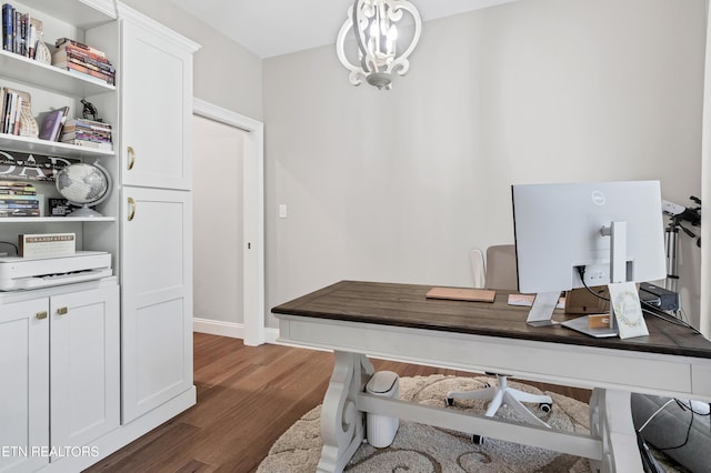 home office featuring dark wood finished floors and a chandelier
