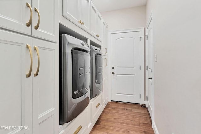 laundry area featuring cabinet space, independent washer and dryer, and light wood-style flooring