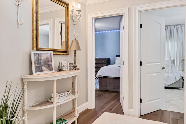 hallway featuring crown molding and wood finished floors