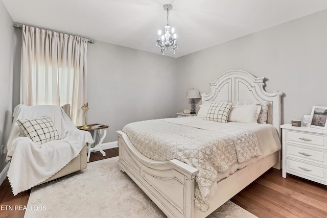 bedroom featuring a chandelier and light wood-style floors