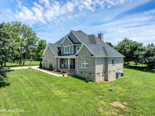 craftsman inspired home featuring crawl space, brick siding, a front yard, and covered porch
