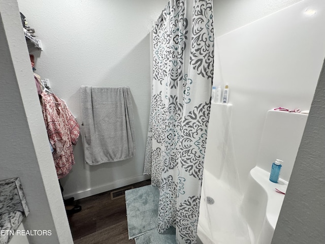 1353 Roy Owens Rd, Jamestown, TN 38556 - full bathroom with wood finished floors and a shower with curtain