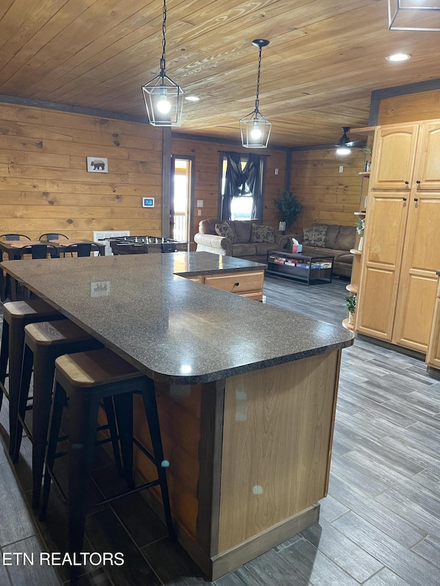 1908 Inskip Ln, Dandridge, TN 37725 - kitchen featuring wood ceiling, a large island, light brown cabinets, wood finished floors, and wood walls