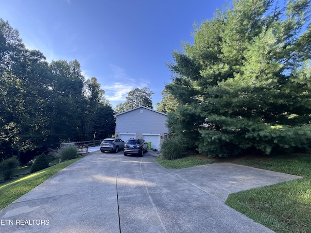 2011 Cedar Ln, Corbin, KY 40701 - view of side of home featuring a garage and concrete driveway