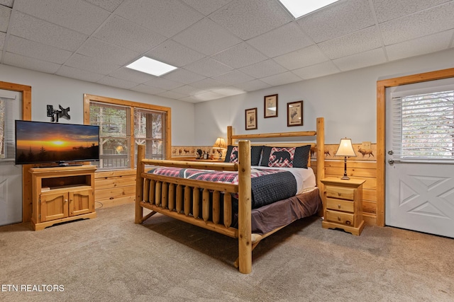716 Golden Eagle Way, Pigeon Forge, TN 37863 - bedroom with light colored carpet, multiple windows, a drop ceiling, a wainscoted wall, and wood walls