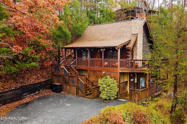 716 Golden Eagle Way, Pigeon Forge, TN 37863 - view of front of property with stairway, a chimney, log exterior, and roof with shingles