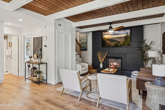 335 Sugar Mountain Way, Pigeon Forge, TN 37863 - living room featuring stairway, a wood ceiling with exposed beams, light wood-type flooring, a ceiling fan, and a tiled fireplace