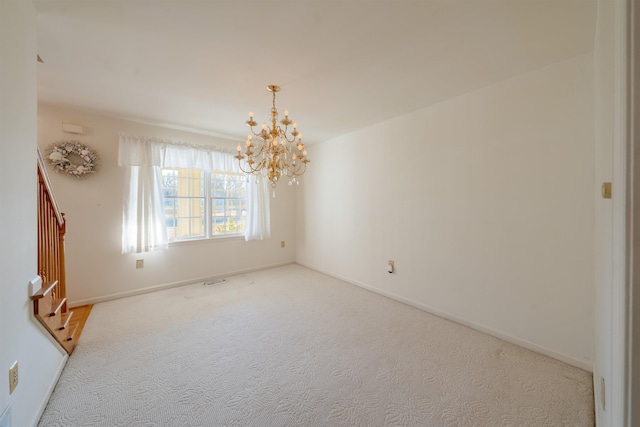 unfurnished room featuring a chandelier, carpet floors, stairway, and baseboards