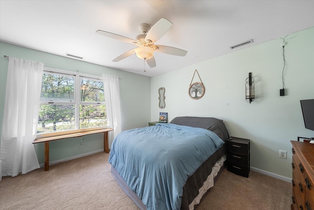 bedroom featuring ceiling fan and light carpet