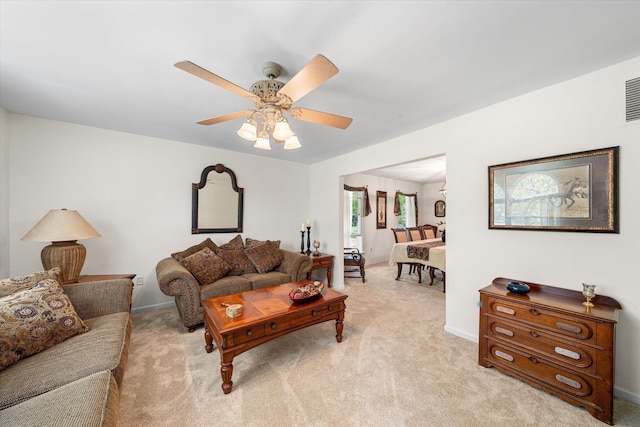 living room with light colored carpet and ceiling fan