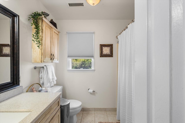 bathroom featuring tile patterned floors, vanity, and toilet