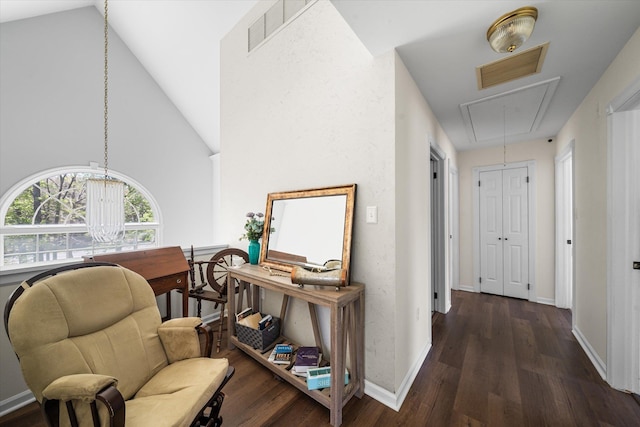 hallway with dark wood-type flooring and vaulted ceiling