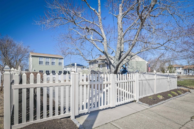 view of gate with a fenced front yard