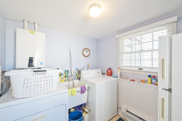 laundry area featuring a baseboard heating unit, a textured ceiling, water heater, separate washer and dryer, and laundry area