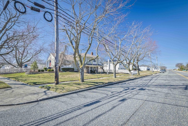 view of road featuring sidewalks, curbs, and a residential view