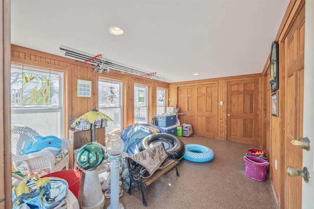 game room featuring recessed lighting and wood walls