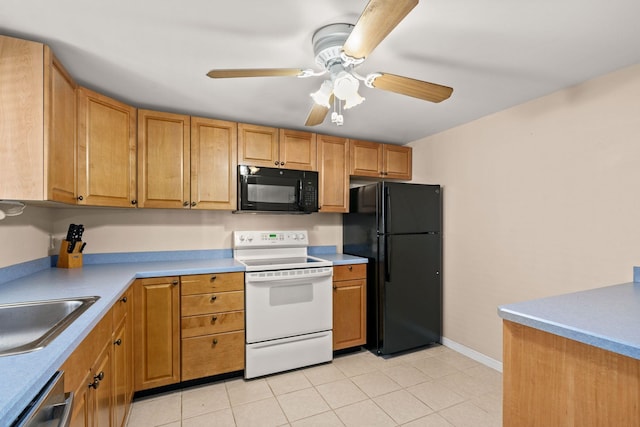 kitchen featuring baseboards, ceiling fan, light countertops, black appliances, and a sink