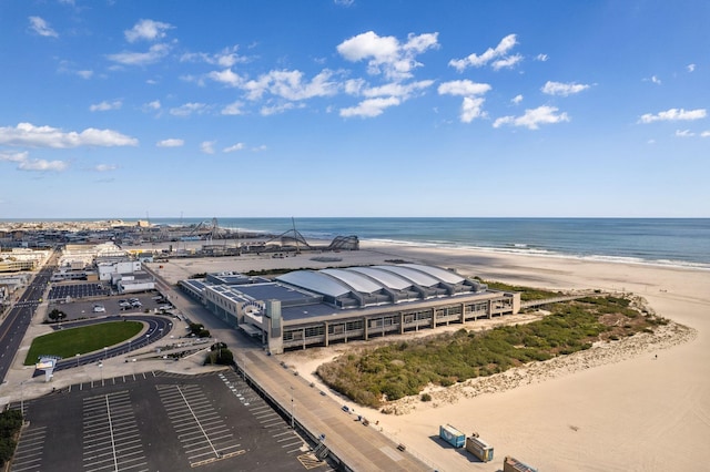 bird's eye view featuring a view of the beach and a water view