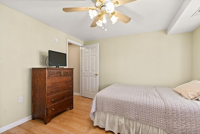 bedroom featuring baseboards, ceiling fan, and light wood-style floors