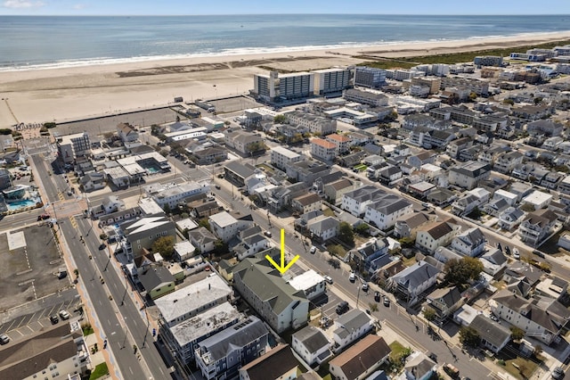 birds eye view of property with a view of the beach and a water view