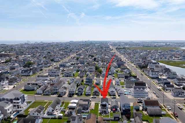 bird's eye view with a residential view and a water view