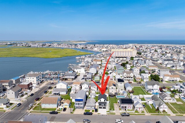 bird's eye view featuring a residential view and a water view