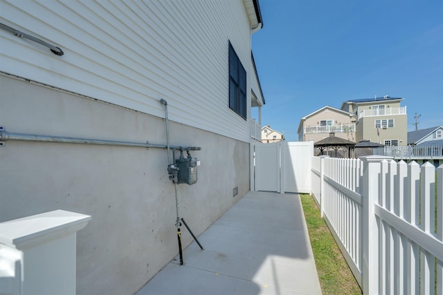 view of side of property featuring a fenced backyard and a patio