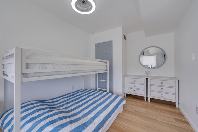bedroom with baseboards, visible vents, and light wood-style floors