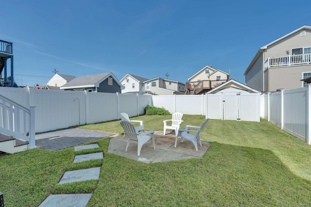 view of yard with a gate, a residential view, a patio, and a fenced backyard