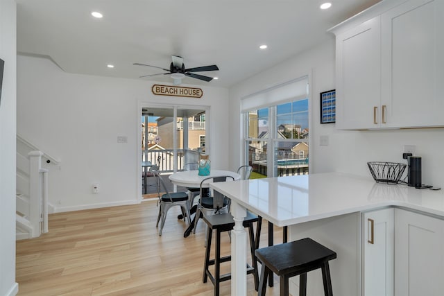 kitchen featuring light wood-style flooring, recessed lighting, white cabinetry, ceiling fan, and light countertops