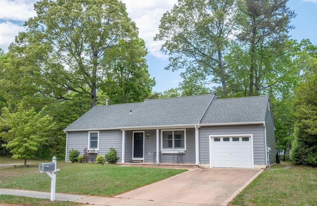 view of front of property featuring a garage, driveway, a front yard, and roof with shingles