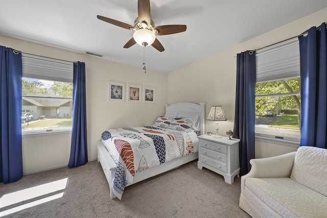bedroom featuring carpet, multiple windows, ceiling fan, and baseboards
