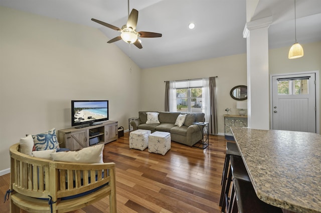 living area with plenty of natural light, wood finished floors, a ceiling fan, baseboards, and high vaulted ceiling
