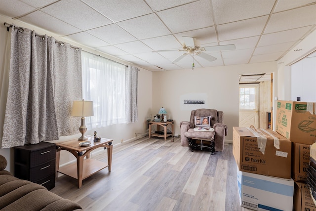 sitting room with a paneled ceiling, ceiling fan, and wood-type flooring