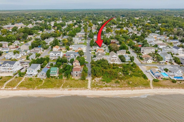 birds eye view of property featuring a view of the beach and a water view