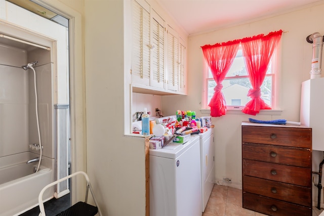 clothes washing area featuring separate washer and dryer and light tile patterned floors