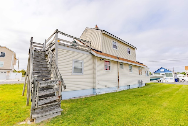 rear view of house with a lawn