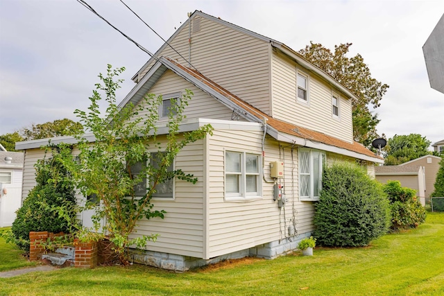 rear view of property with a lawn