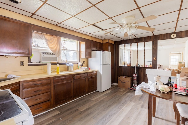 kitchen featuring a drop ceiling, white refrigerator, cooling unit, ceiling fan, and wood-type flooring